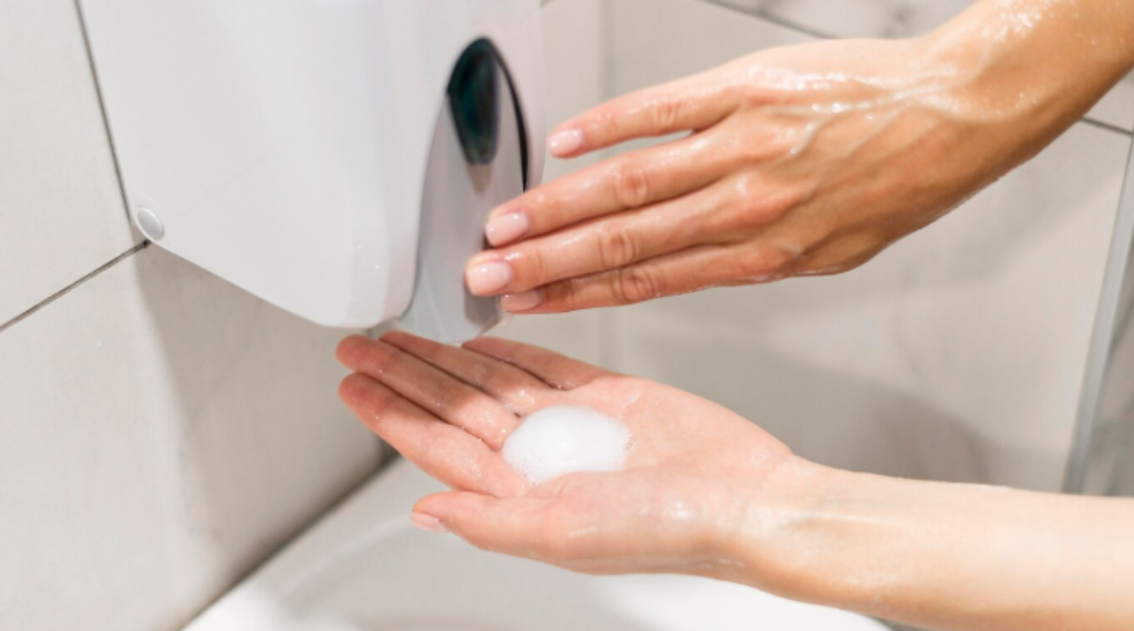 Person using a soap dispenser