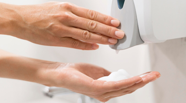 Person using a soap dispenser
