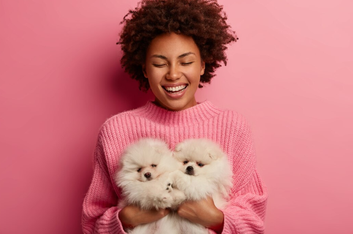 Woman holding her pet dogs