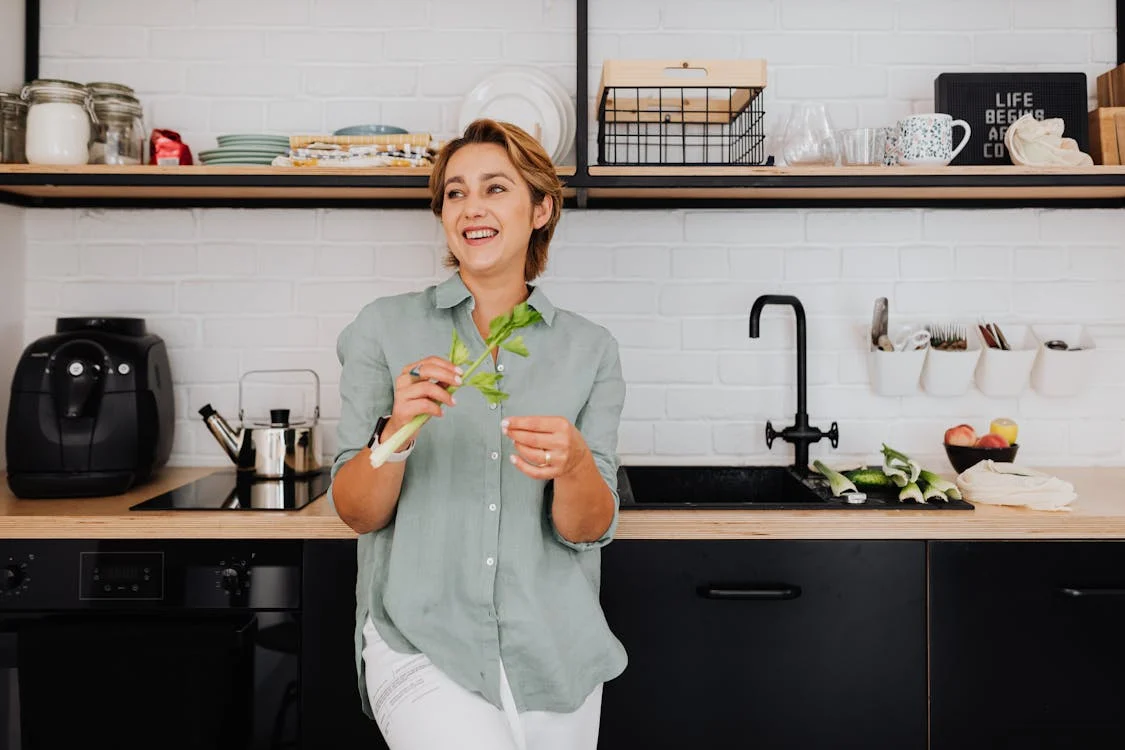 A woman in the kitchen next to an air fryer
