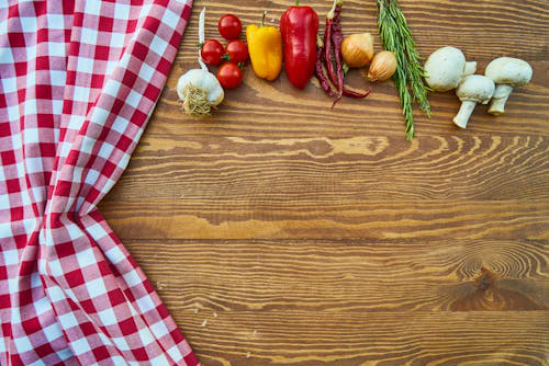 Colorful veggies and apron on a wooden table