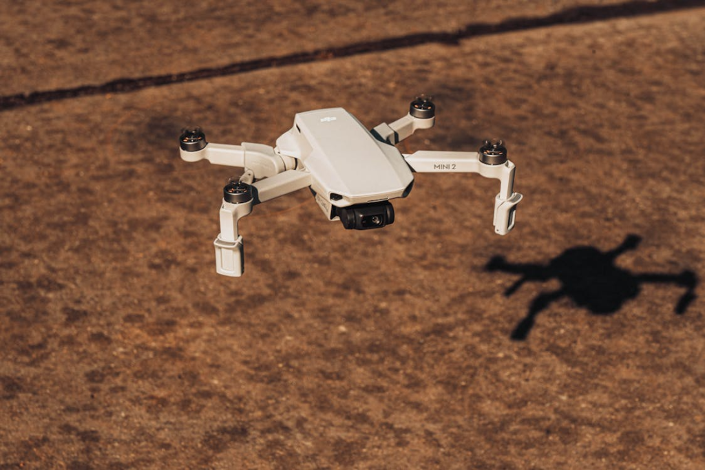 A modern drone hovering steadily midair during daytime