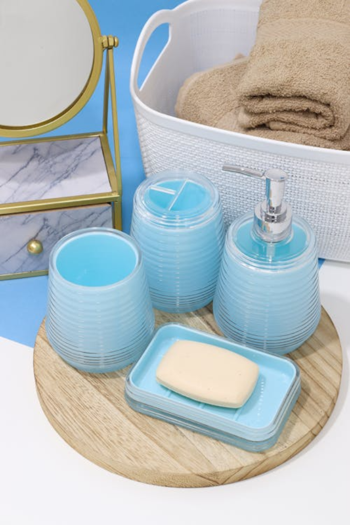 A soap dish and glass dispensers neatly arranged on a wooden board for a clean, coordinated aesthetic