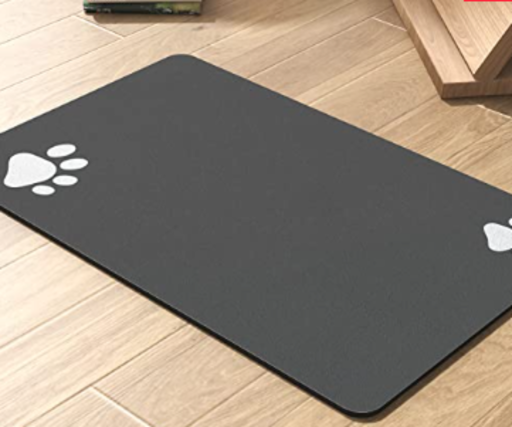 Gray absorbent dog mat placed under food and water bowls.