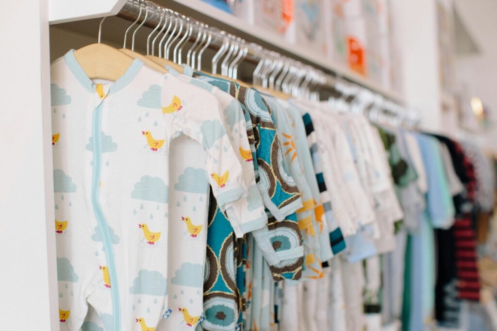 a row of hanging baby clothes