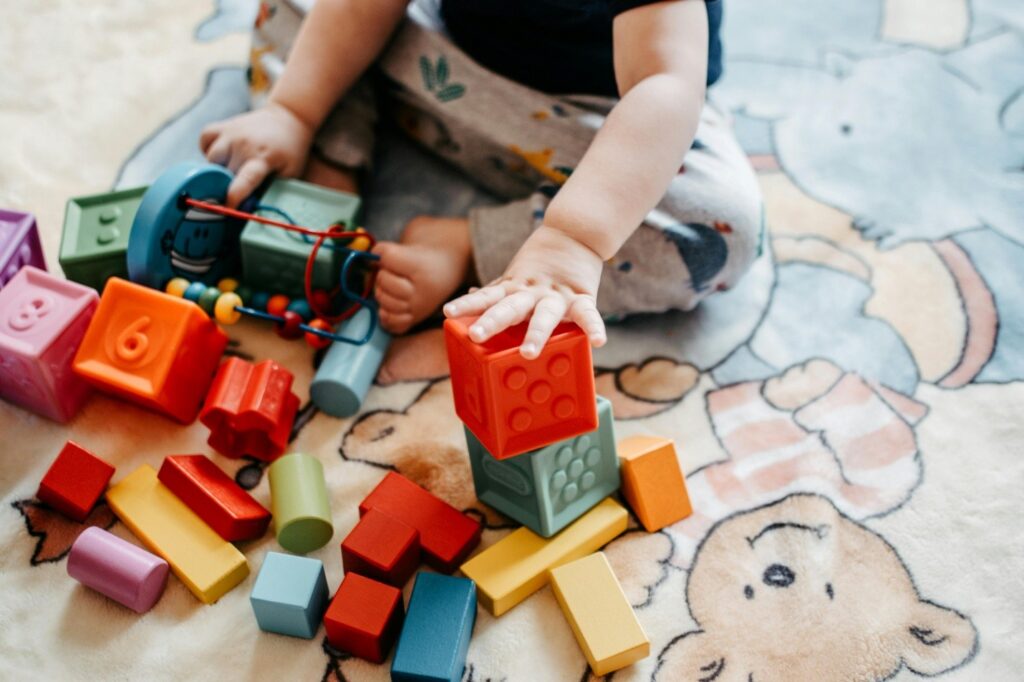 a baby playing with wooden blocks