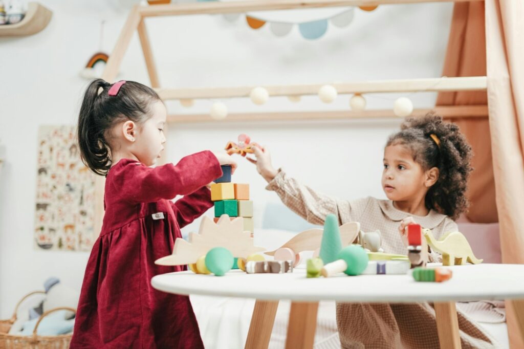 two girls playing with building blocks