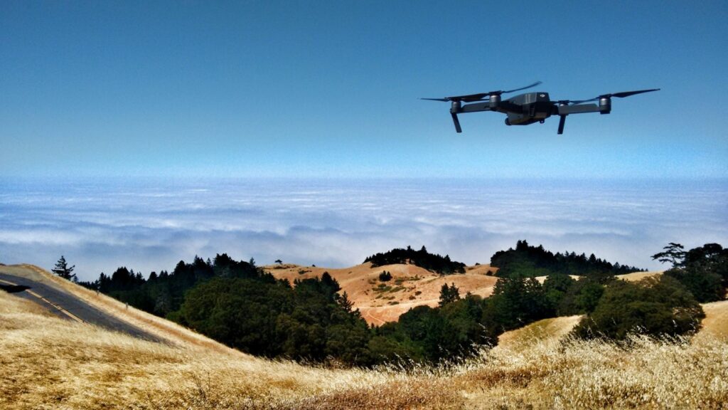 a drone flying over a hilly region