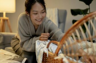 a mother playing with a child in a bassinet