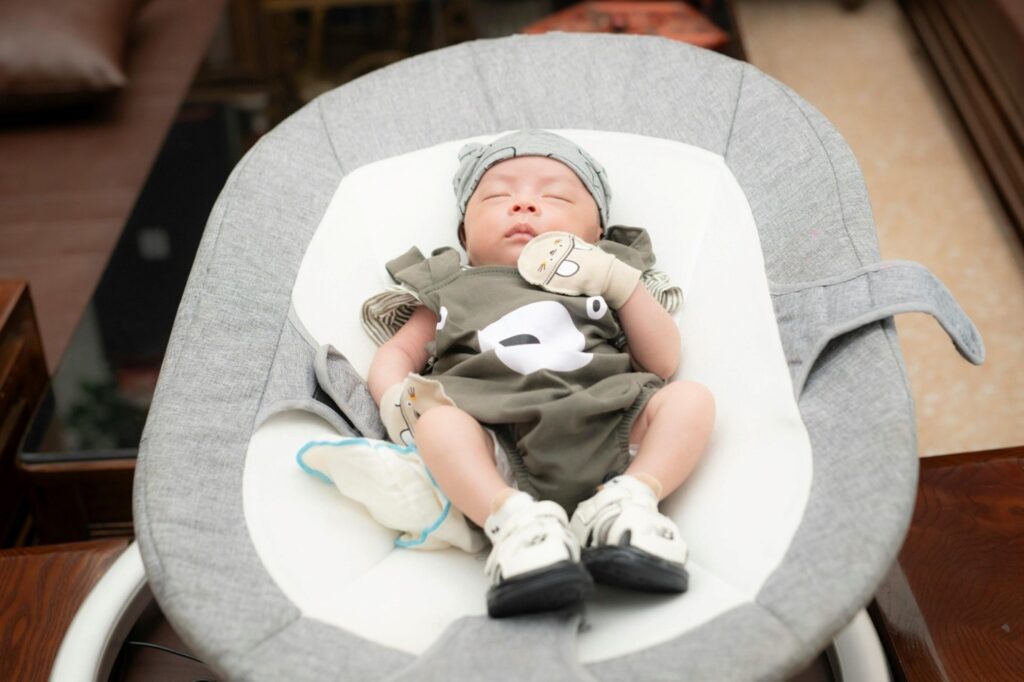 a baby sleeping in a bassinet